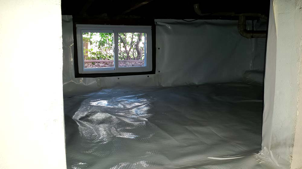 Dirt crawl space with poly membrane liner and new window installation | Eco-Dry Waterproofing