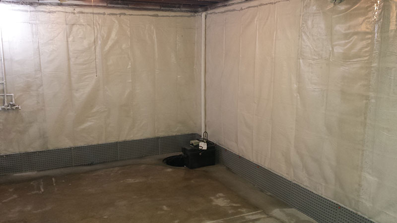 Finished basement with mold remediation and vapor barrier on wall | After