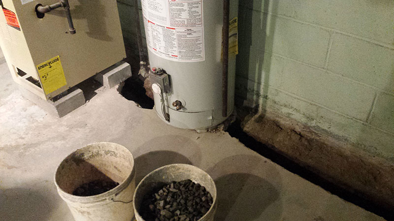 Installation of french drain under water heater and furnace (angle 1) | Before